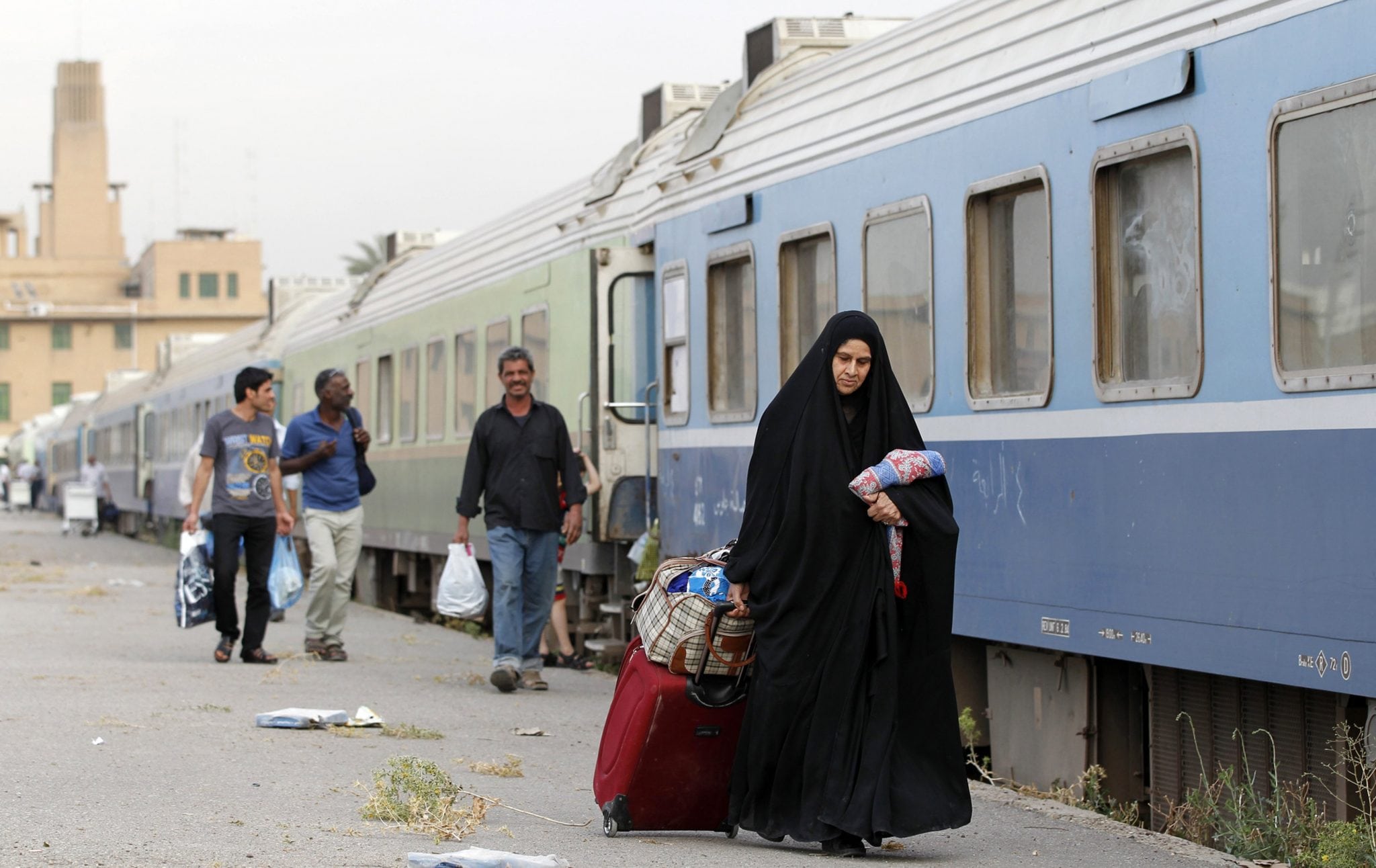 A passenger walks beside a train in a train station in Baghdad. 