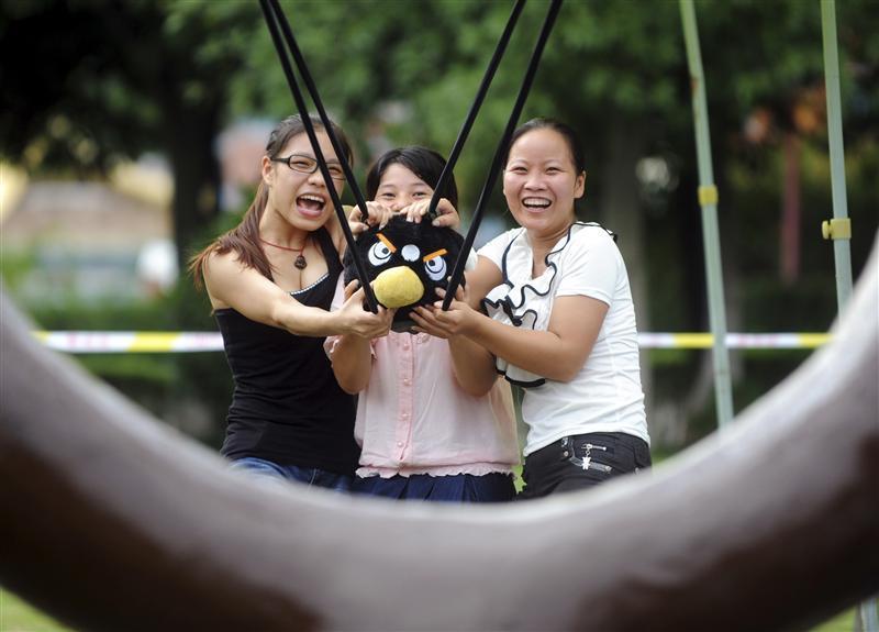 Visitors use a slingshot to shoot an Angry Bird plush toy at a real life Angry Birds outdoor game in a theme park at Changsha, Hunan province.