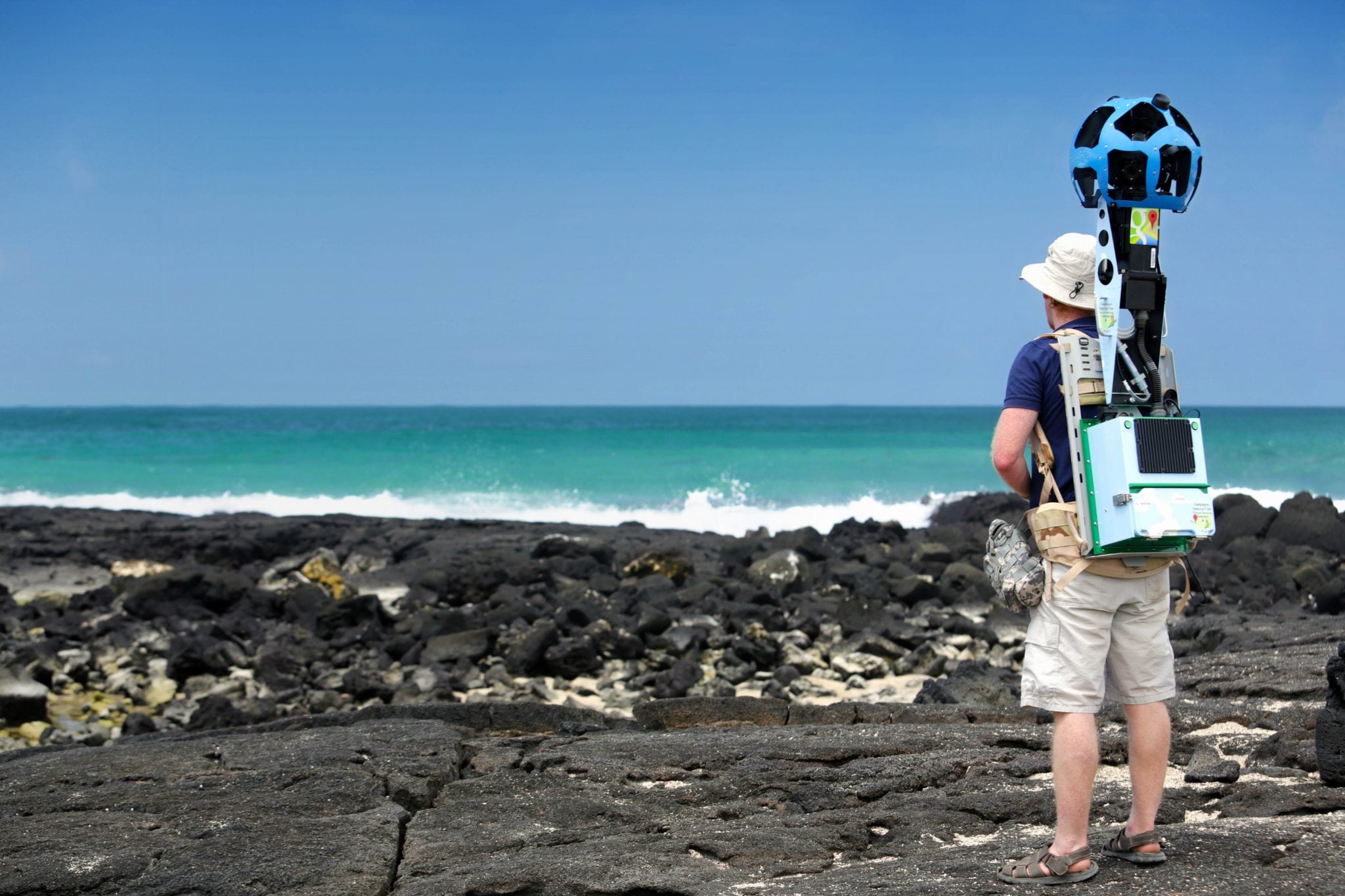 In this May 2013 photo provided by Google, Daniel Orellana of the Charles Darwin Foundation collects seashore imagery with the Street View Trekker at the Los Humedales wetland area on Isabela Island in the Galapagos. 