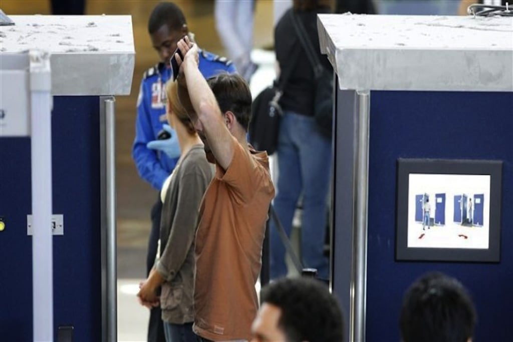 A man is screened with a backscatter x-ray machine at a TSA security checkpoint in terminal 4 at LAX, Los Angeles International Airport, in Los Angeles.
