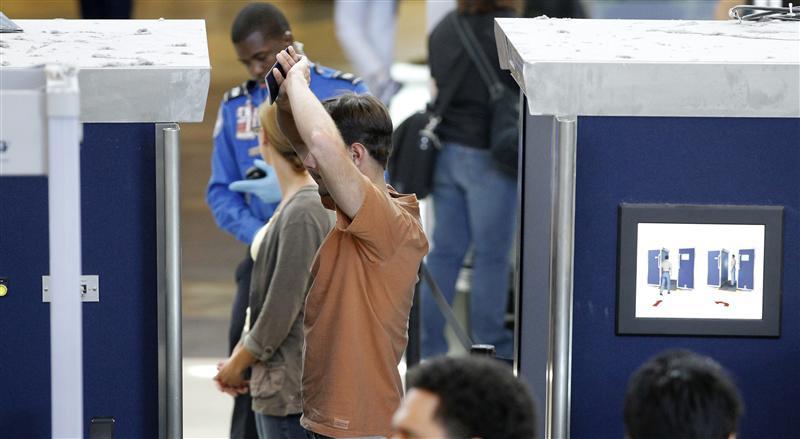 A man is screened with a backscatter x-ray machine at a TSA security checkpoint in terminal 4 at LAX, Los Angeles International Airport, in Los Angeles. 