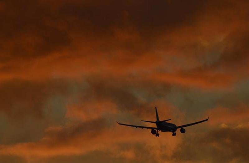 A passenger plane flies in to land at Heathrow Airport in west London. 