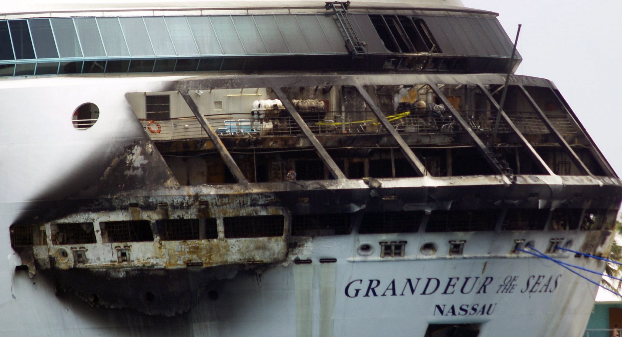 The fire-damaged exterior of Royal Caribbean's Grandeur of the Seas cruise ship is seen while docked in Freeport, Grand Bahama island, Monday, May 27, 2013. 