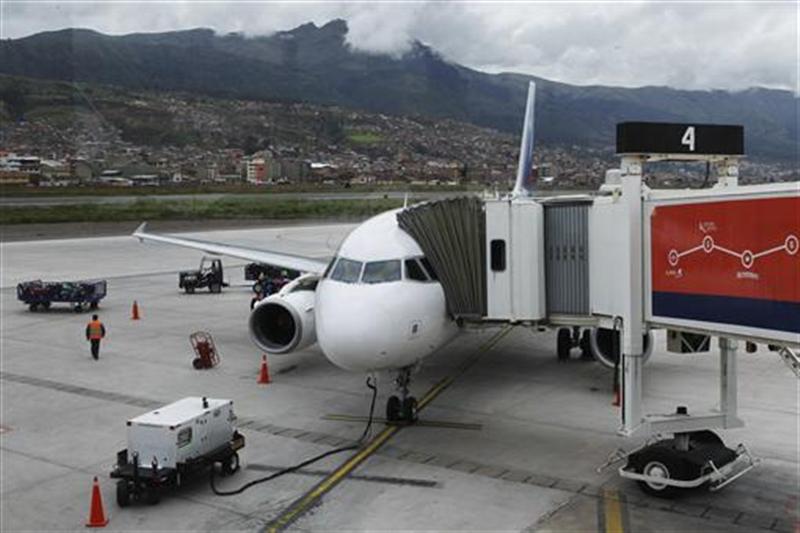 Workers prepare a LAN Airlines plane before its take off from Cuzco to Lima, in the first Latin American flight using the Required Navigation Performance system. 