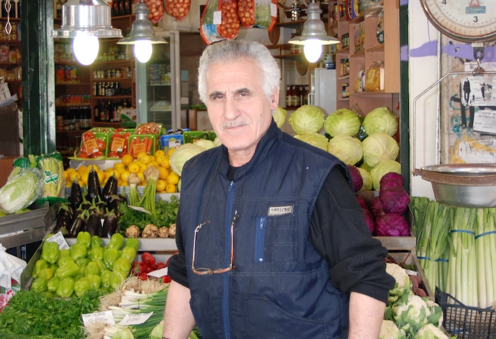 A Greek man stand in front of his grocery in the city of Thessaloniki. 