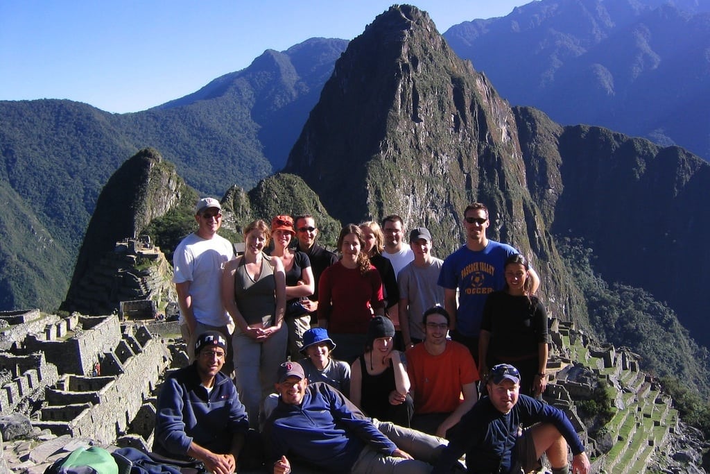 Tourists pose at the top of Machu Picchu at the end of  three-day hike. 