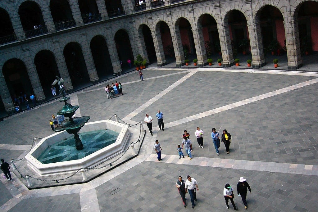 Tourists walk through the courtyard inside the Palacio Nacional by the Zócalo in Mexico City. 