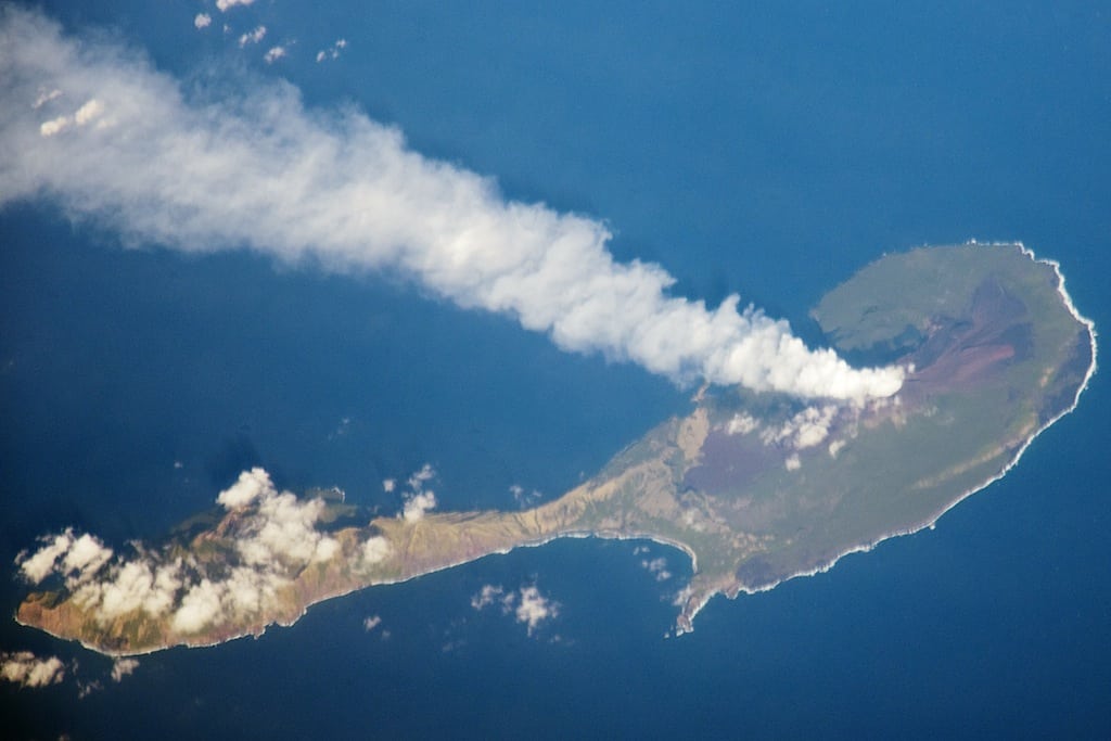 A steam plume flows blows south from the peak of Pagan Island’s northernmost volcano in this photograph by an astronaut on the International Space Station (ISS). 