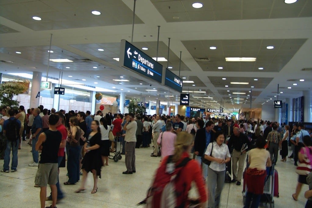 The arrivals concourse is crowded at Sydney Airport. 