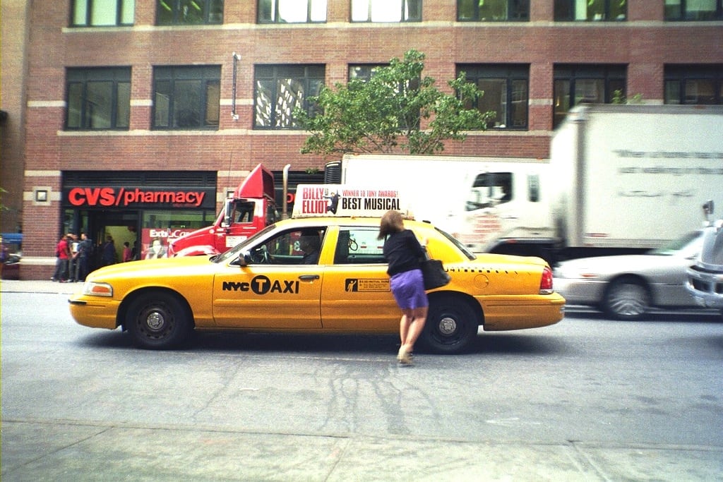 A woman rushes to catch her cab in New York City. 