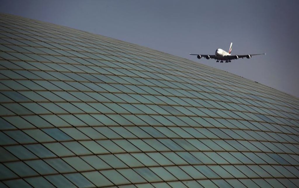 An Emirates airlines Airbus A380 comes in for landing over the roof of the Beijing Capital International Airport's train station March 6, 2012. 