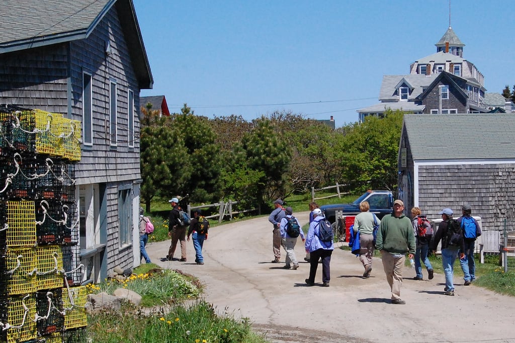 Visitors get ready to walk the birding trail in Monhegan Island, Maine. 