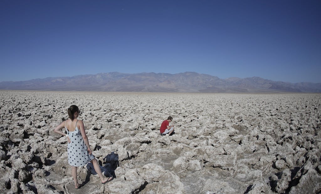 Eric Varone, right, takes a picture as Floriane Golay, of Switzerland watches, in Death Valley National Park Friday, June 28, 2013 in Badwater, California.