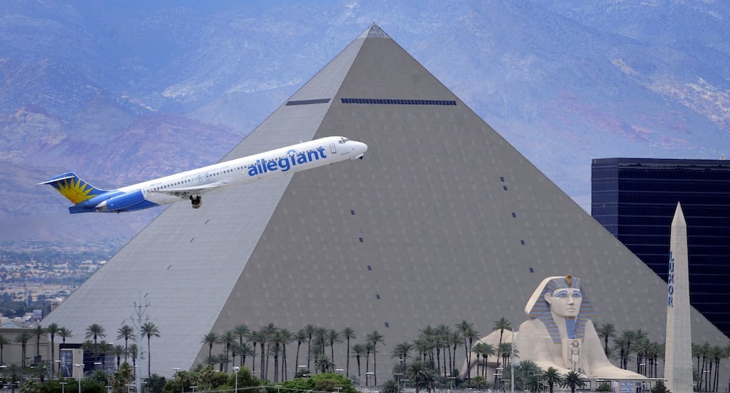 In this Thursday, May 9, 2013, photo, an Allegiant Air jetliner flys by the Luxor Resort & Casino after taking off from McCarran International Airportm in Las Vegas. (AP 
