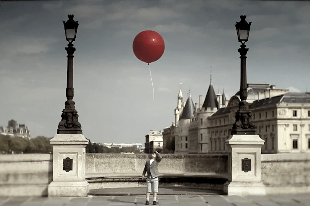 A young boy watching a red balloon float away in the airline's newest online ad. 