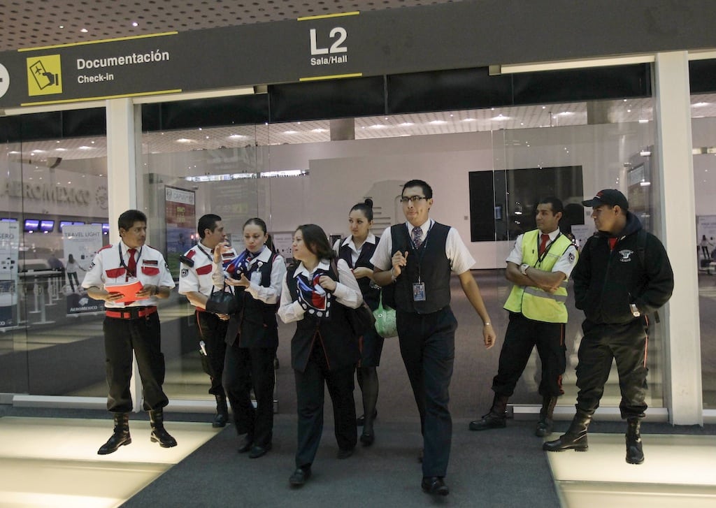 Aeromexico flight attendants and other staff leave an Aeromexico counter at Mexico City's international airport June 1, 2013.  