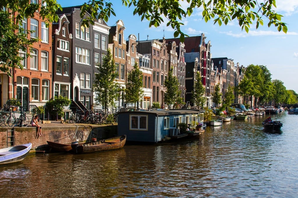 A house boat sits on the river in Amsterdam. 