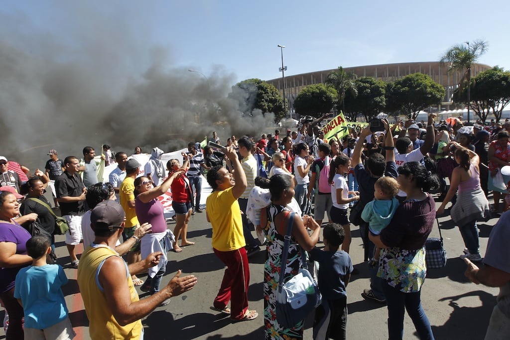Demonstrators protest outside the National Stadium in Brasilia, Brazil, Friday, June 14, 2013. 