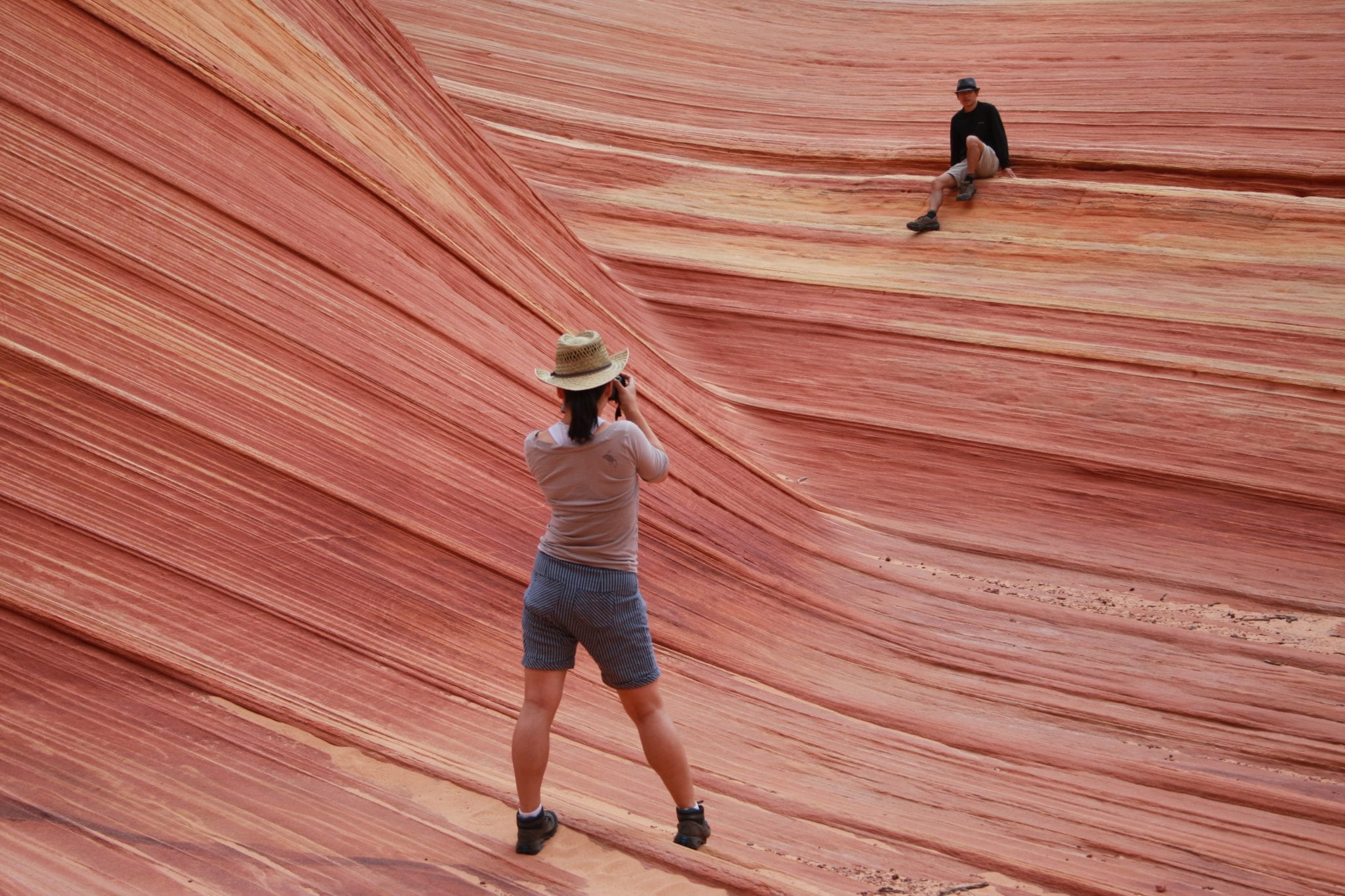 This May 28, 2013 photo shows a hiker taking a photo on a rock formation known as The Wave in the Vermilion Cliffs National Monument in Arizona. 