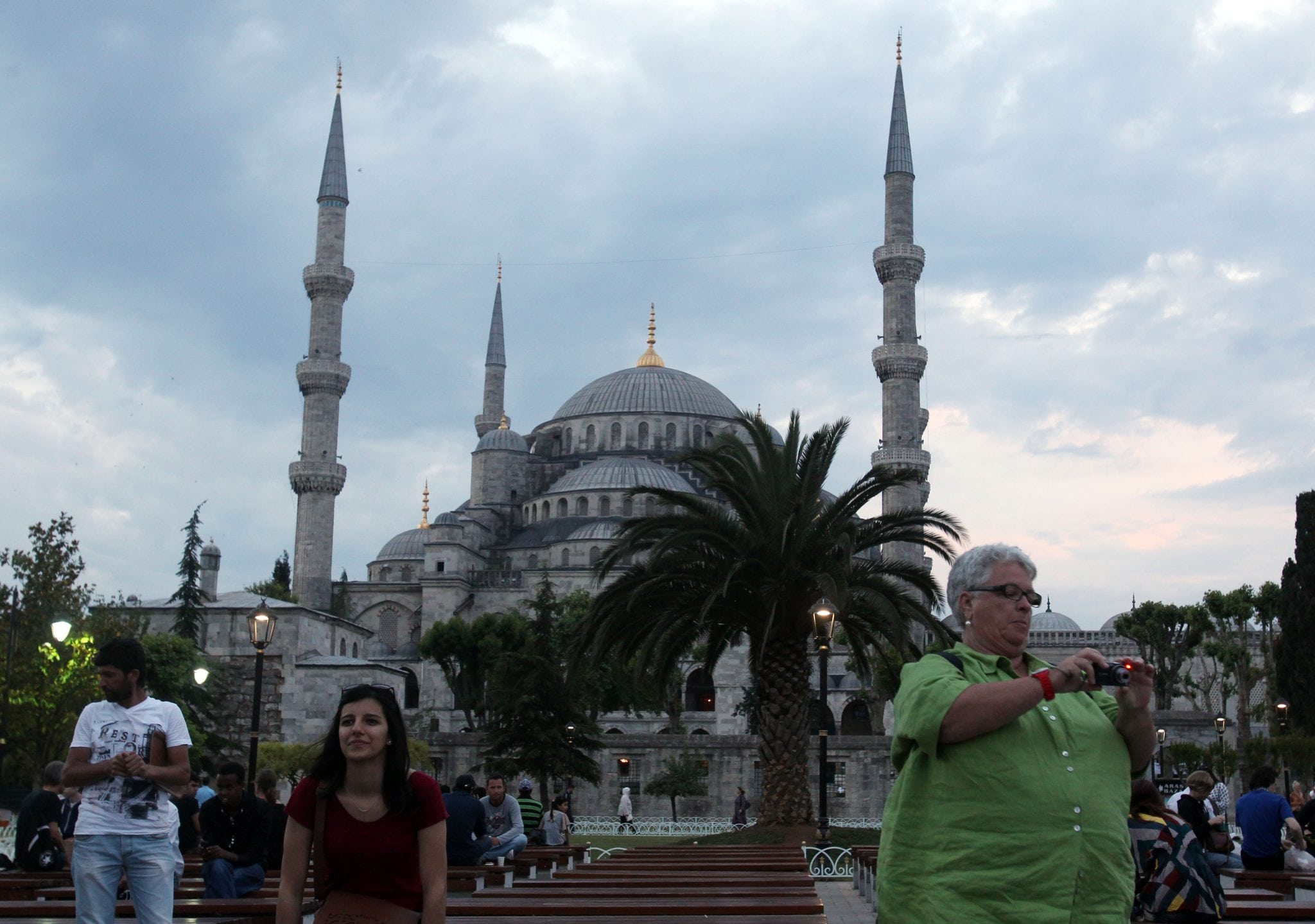 Tourists take photographs in front of the Blue Mosque in Sultanahmet tourist area of Istanbul, late Tuesday, June 4, 2013. 
