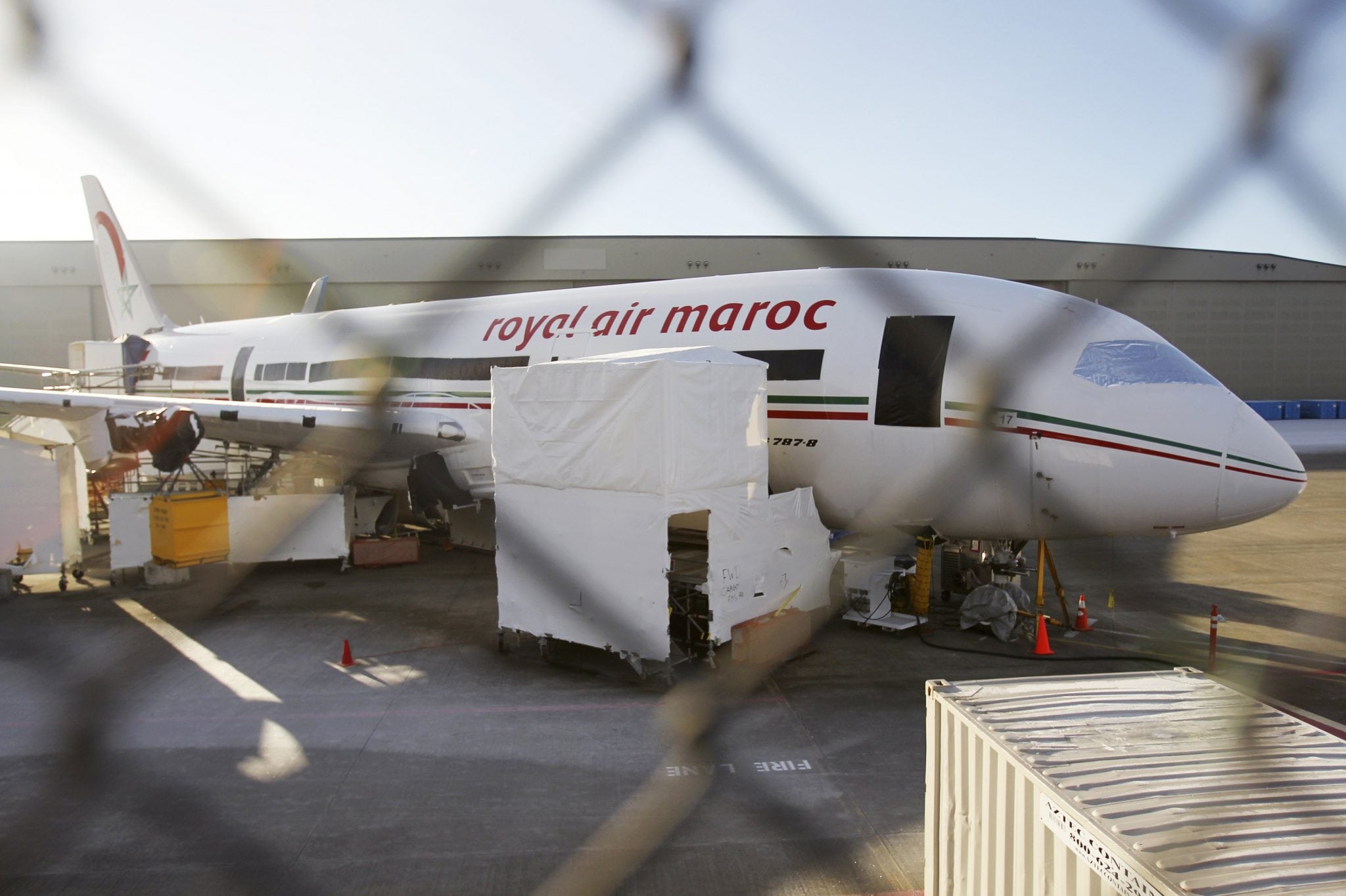 A 787 Dreamliner jet painted in Royal Air Maroc livery, sits idle on the tarmac parking at Paine Field in Everett. 