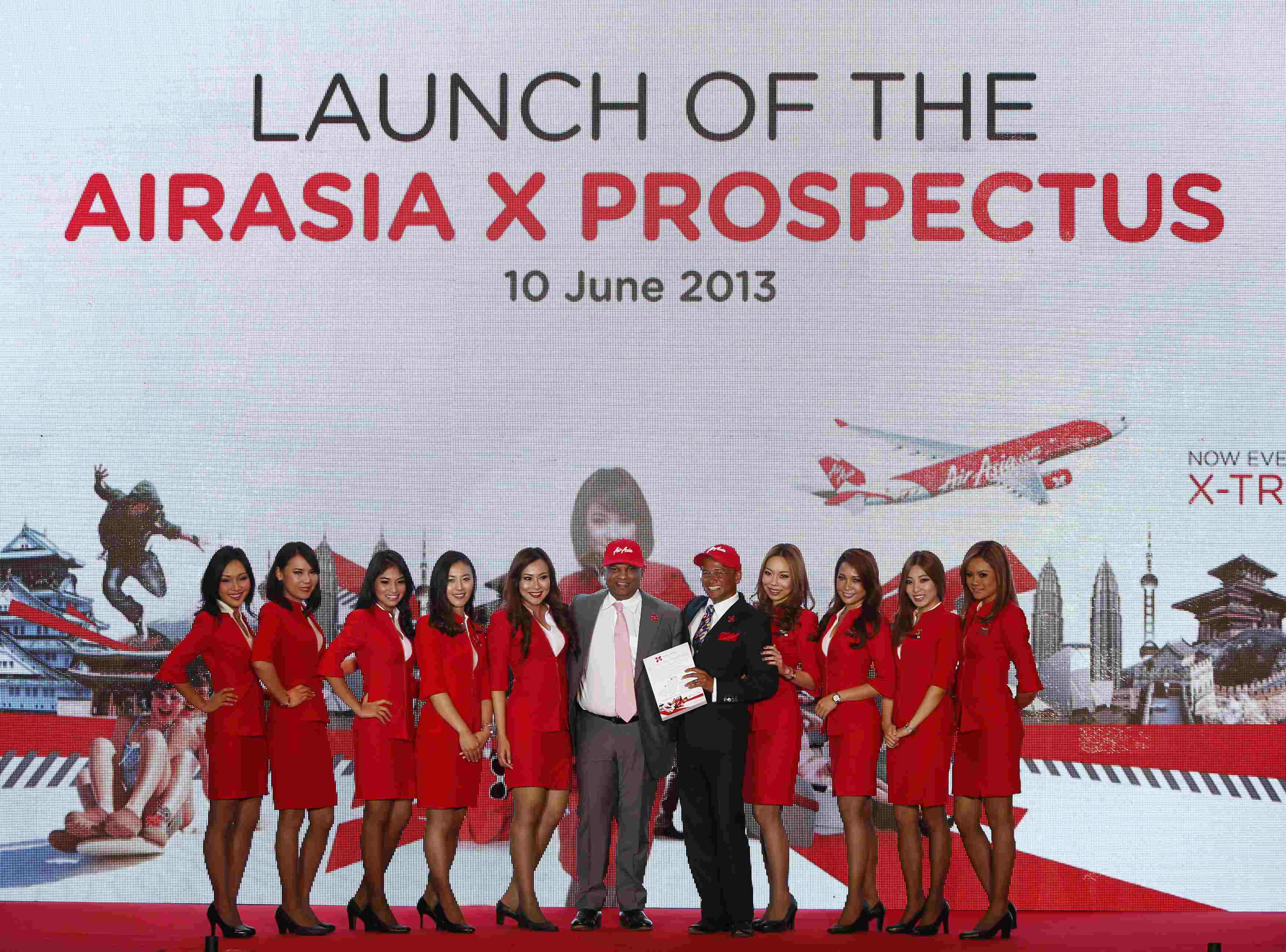 Fernandes, founder of long-haul carrier AirAsia X, and CEO Osman-Rani hold a newly launched AirAsia X Prospectus as they pose during its launch ceremony in Kuala Lumpur. 