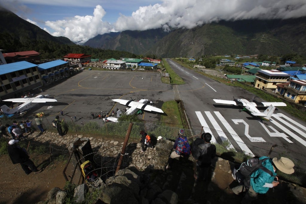 In this Sunday, May 26, 2013 photo, several flights get ready to take off after a couple of days of bad weather disrupted flight services at Lukla airport, Nepal. 