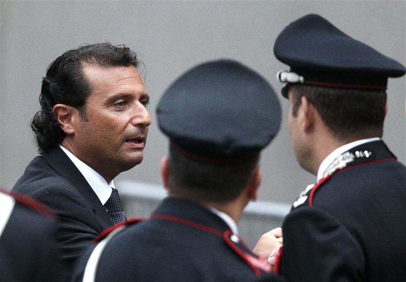 The captain of the Costa Concordia Schettino is surrounded by Italian Carabinieri policemen as he leaves at the end of the preliminary hearings in Grosseto. 