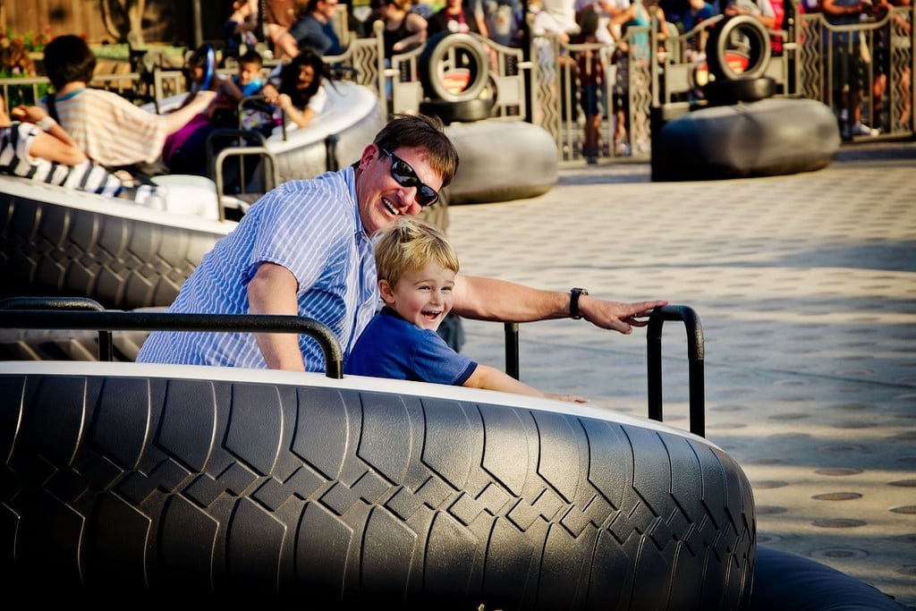 A father and son on Luigi's Tire Ride at Cars Land in Disney's California Adventure Park. 