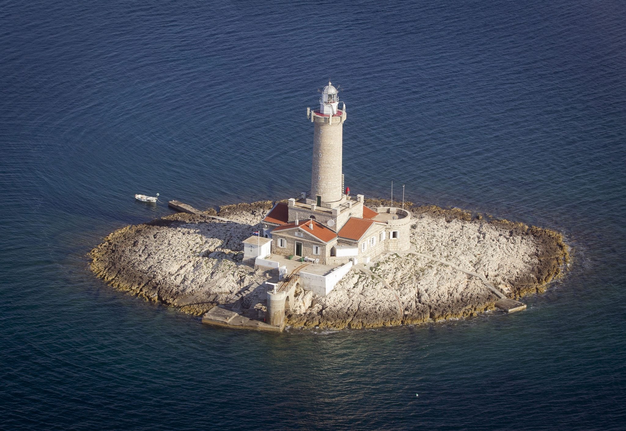 A lighthouse Porer in northern Adriatic is photographed from the air. The lighthouse is used for tourist accommodation.