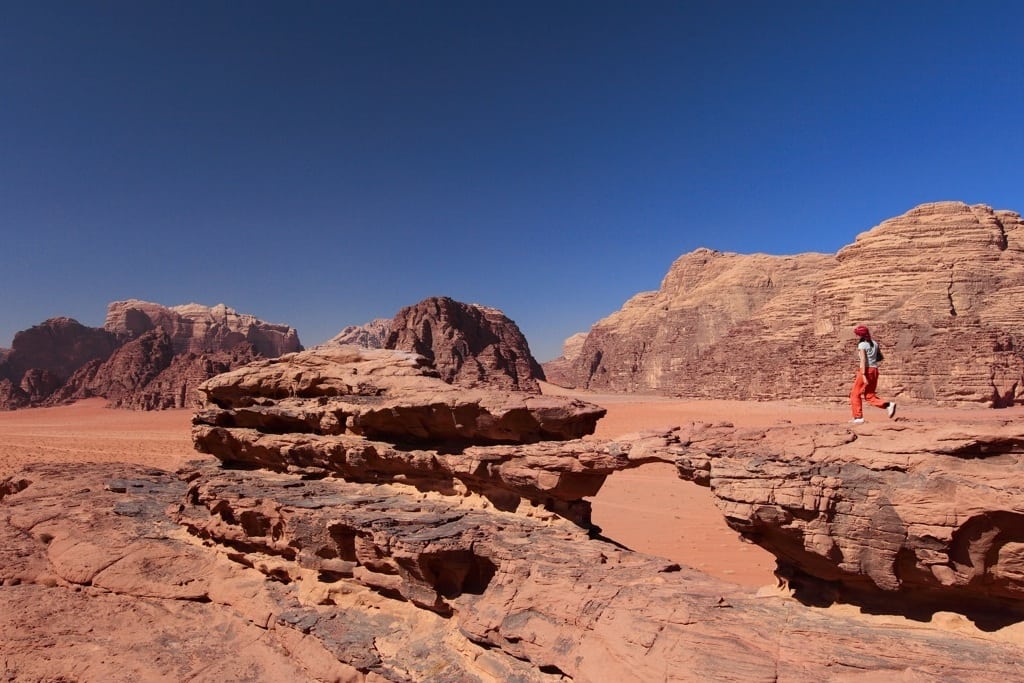 A traveler walks through Wade Rum, a desert valley in Jordan. 