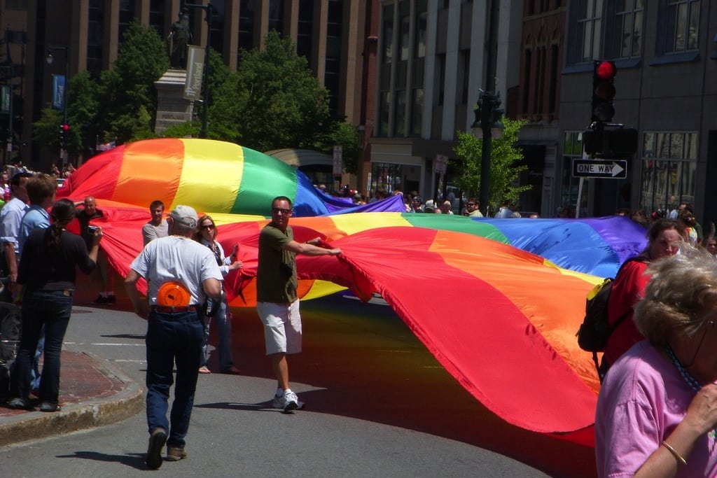 Parade participants carry a rainbow flag at the Southern Maine Pride parade in Portland, Maine. 