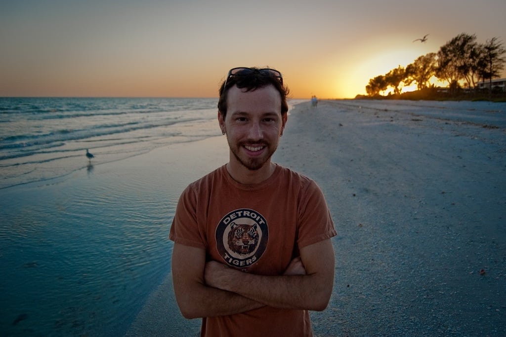 A visitor poses in front of the sunset on Sanibel Island in Florida. 