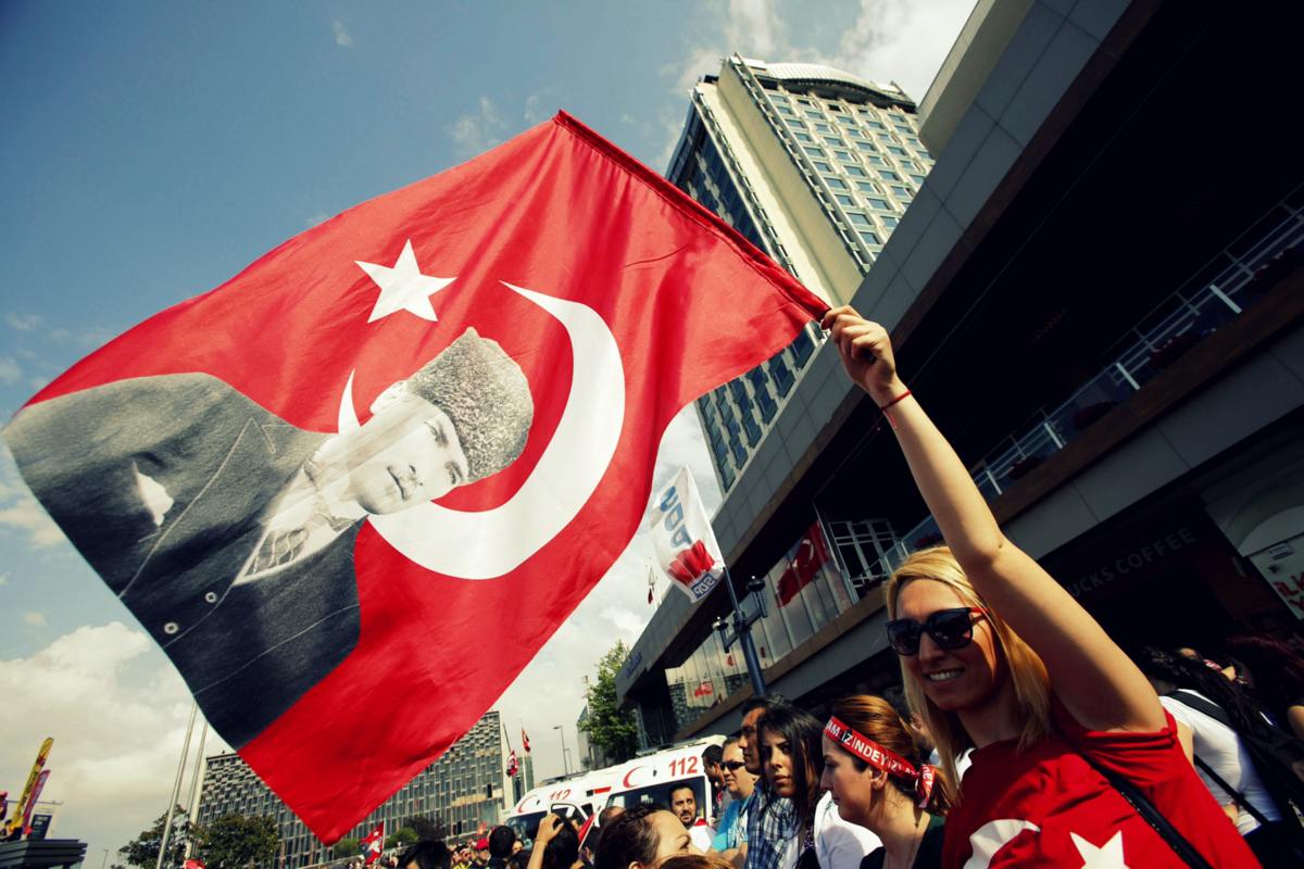 A demonstrator waves a Turkish flag with a portrait of Mustafa Kemal Ataturk during an anti-government protest at Taksim Square in central Istanbul June 2, 2013.