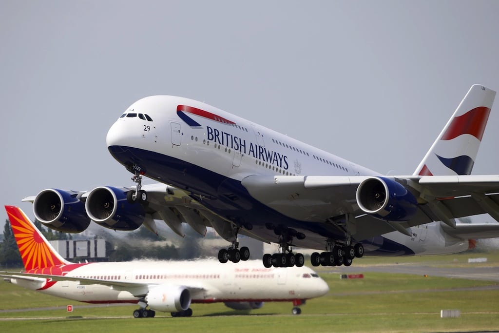 A British Airways Airbus A380, right, takes off in front of an Air India Boeing 787 Dreamliner during the first day of the 50th Paris Air Show at Le Bourget airport.