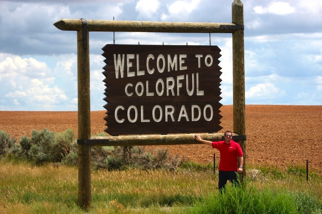 A traveler takes a photo at the Colorado border near Dove Creek. 