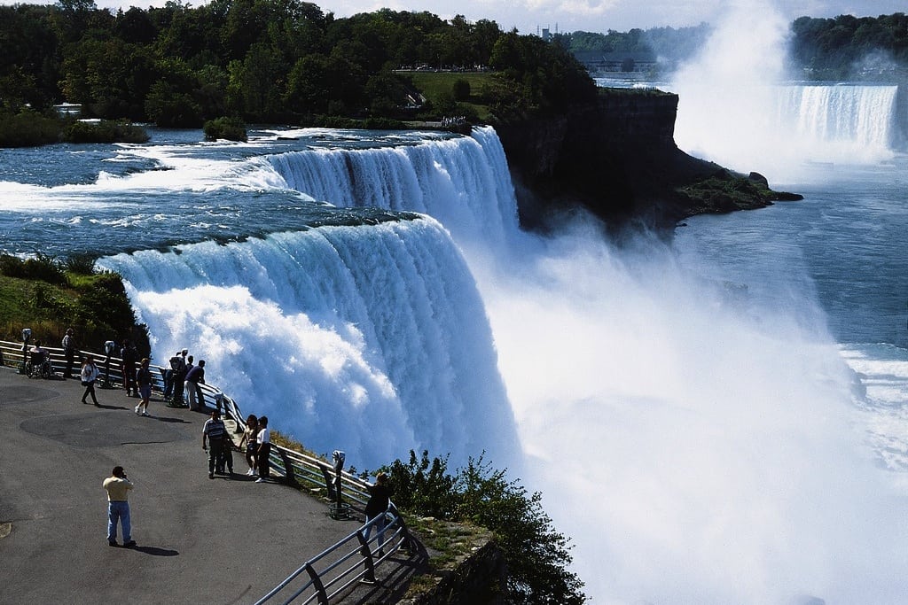Visitors walk along the New York side of the Niagara Falls. 