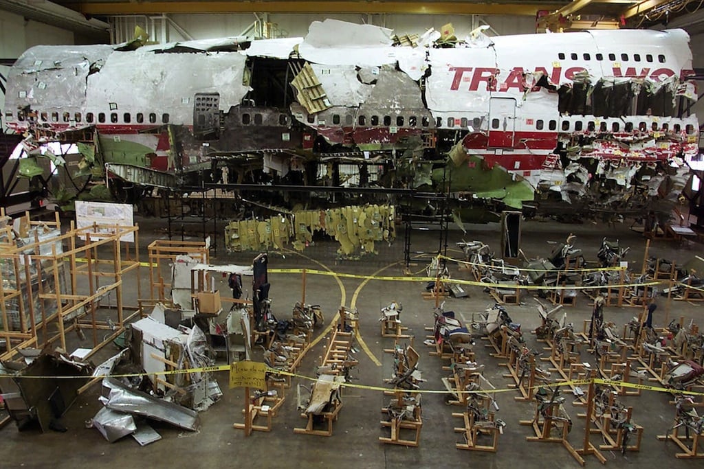This July 16, 2001 file photo shows the seats, foreground, and the wreckage of TWA Flight 800 in a hangar in Calverton, N.Y. Current and former federal officials who played key roles in the investigation of one of the nation's worst aviation disasters said Tuesday, July 2, 2013 they stand by their conclusion that the crash of flight 800 was caused by an accidental fuel tank explosion, and not a bomb or missile. 