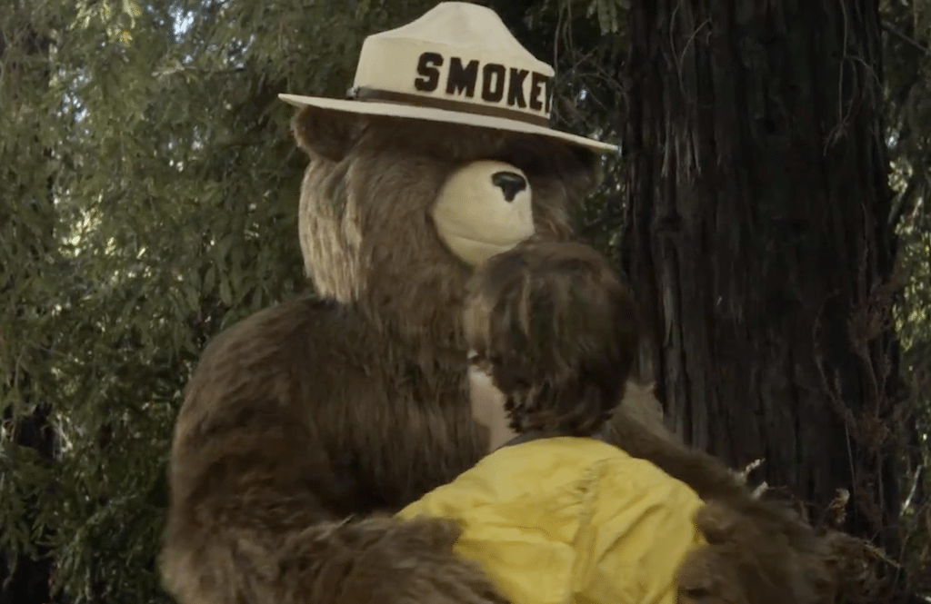 Smokey Bear now freely dispenses hugs in new public service announcements geared to prevent wildfires.