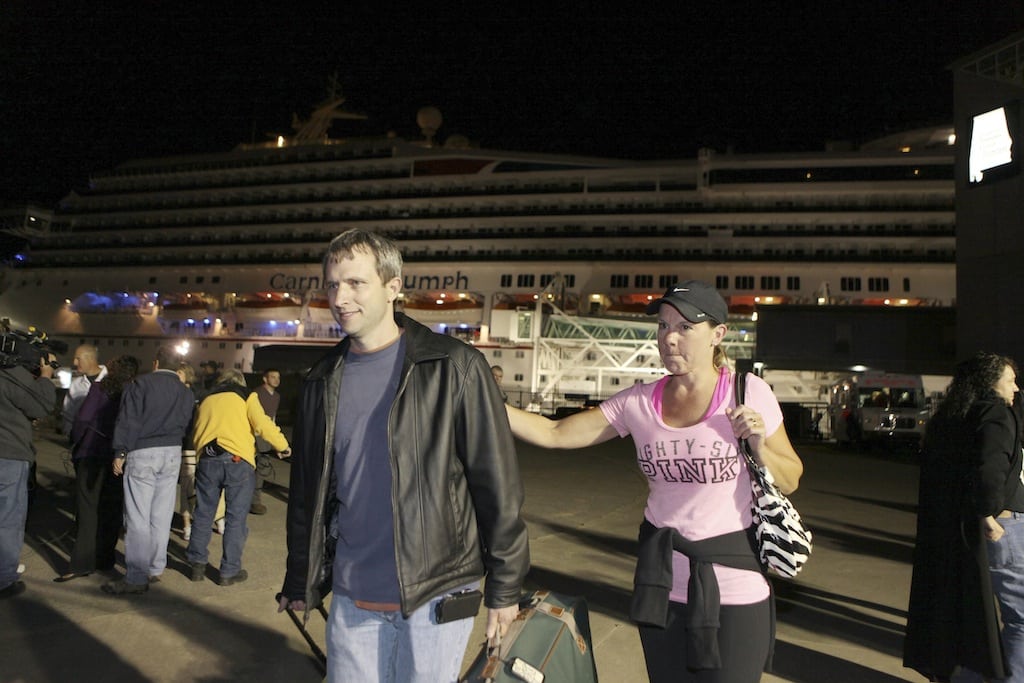 Passengers leave the Carnival Triumph cruise ship after reaching the port of Mobile, Alabama, February 14, 2013. Four months later, Carnival didn't let anyone know that the Triumph failed an inspection just before it was set to return to service.  