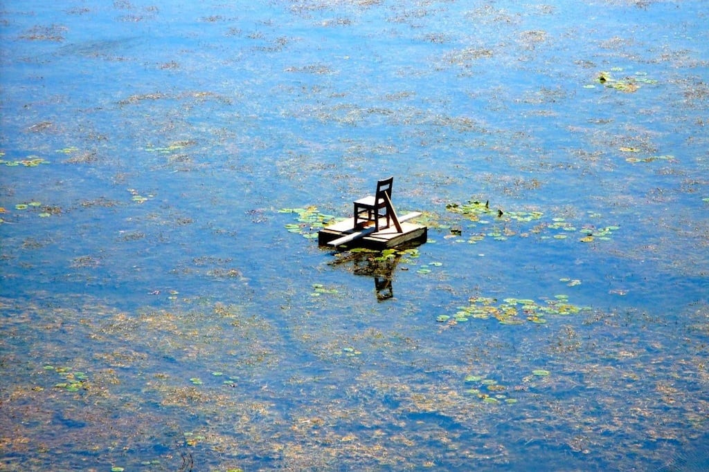 Algae surround a lone fishing chair on Lake Erie near Norfolk County, Ontario. 