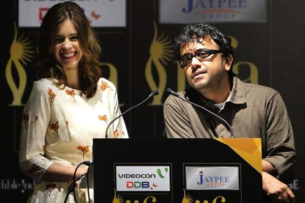 Bollywood actress Kalki Koechlin smiles as director Dibakar Banerjee (R) speaks during the opening news conference of the 13th International Indian Film Academy (IIFA) Awards in Singapore June 7, 2012. 