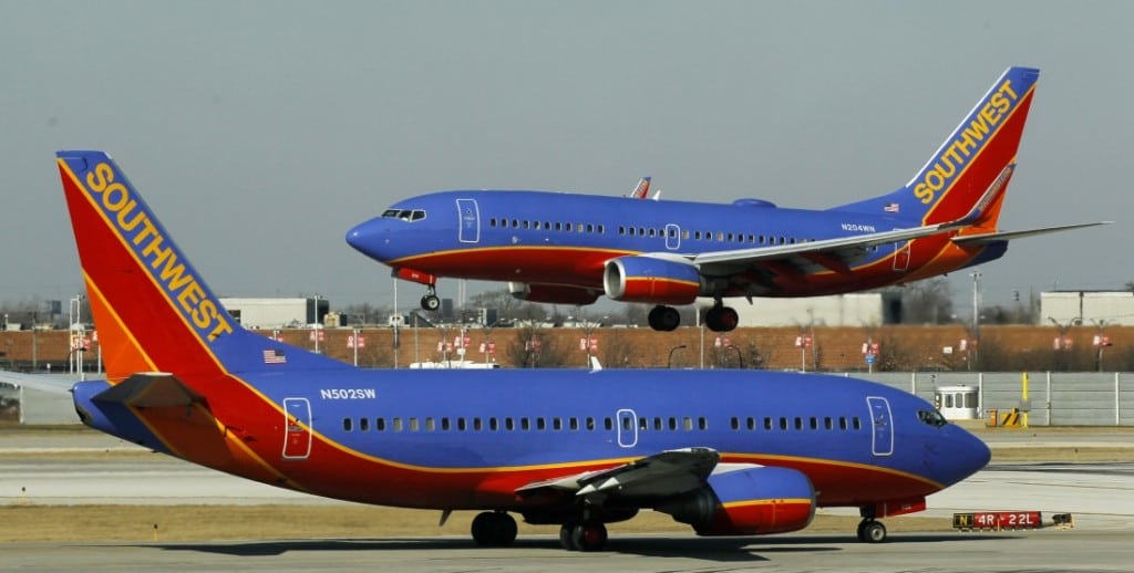 In this Feb. 9, 2012 photo, a Southwest Airlines Boeing 737 waits to take off at Chicago's Midway Airport as another lands.