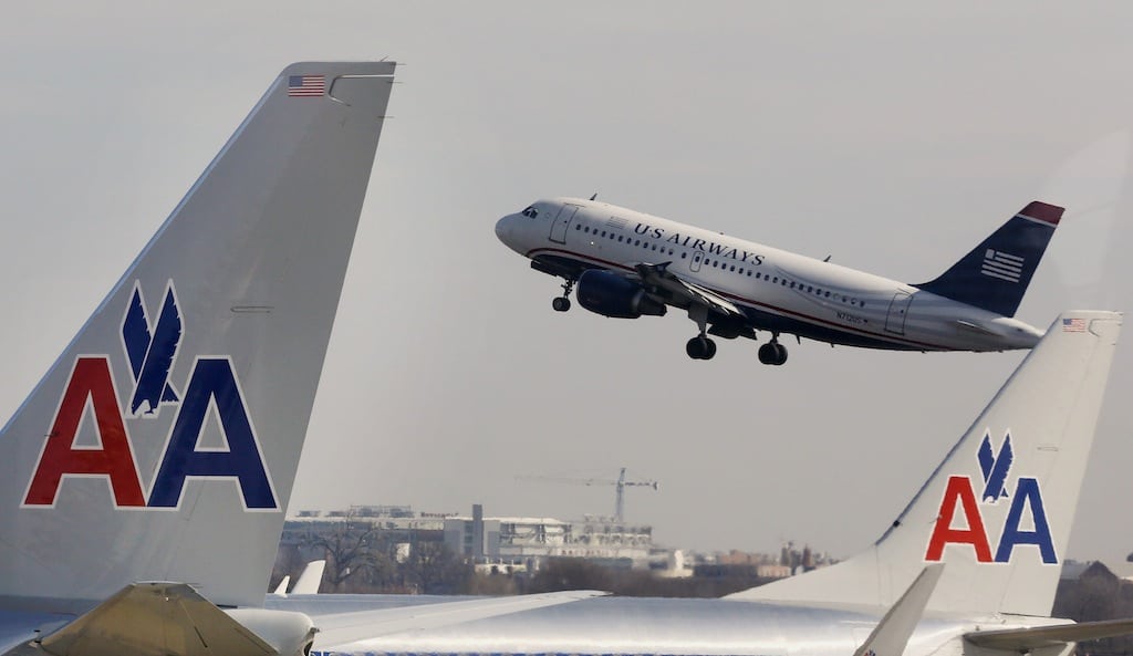 A U.S. Airways jet departs Washington's Reagan National Airport next to American Airlines jets outside Washington, in this file photo from February 25, 2013. 