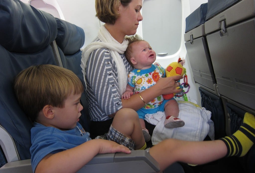 A family gets comfortable in coach class. 