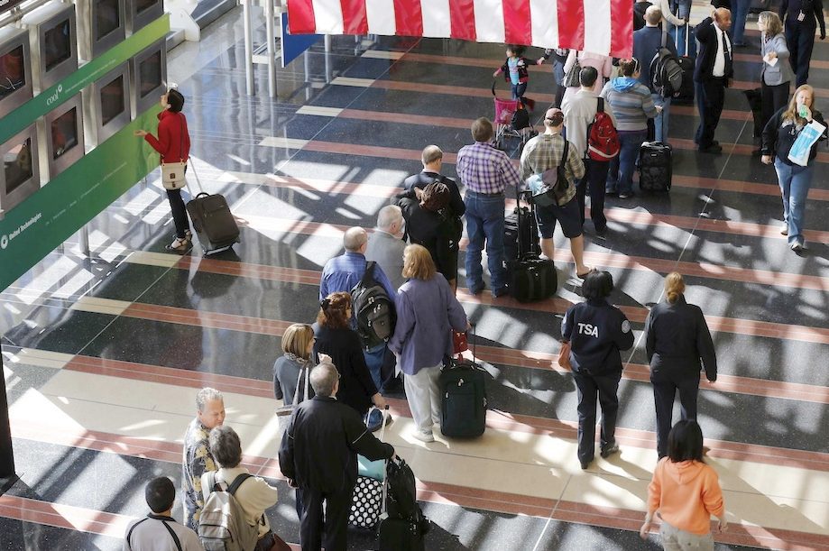 Reagan National Airport in Washington, D.C., gets its fair share of government travelers using the General Services Administration's City Pair Program. Here, a line of passengers wait to enter the security checkpoint before boarding their aircraft at DCA on April 25, 2013. 