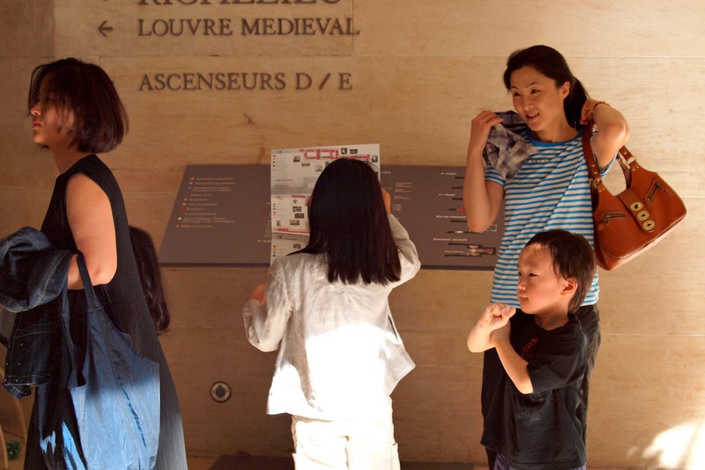 Chinese tourists at the Louvre museum in Paris, France. 