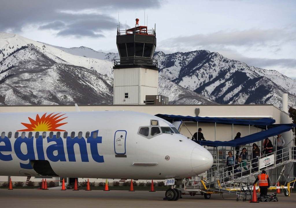 Passengers walk next to an Allegiant Air in Ogden, Utah. Lukas Johnson, the executive in charge of what routes the airline flies, is leaving.