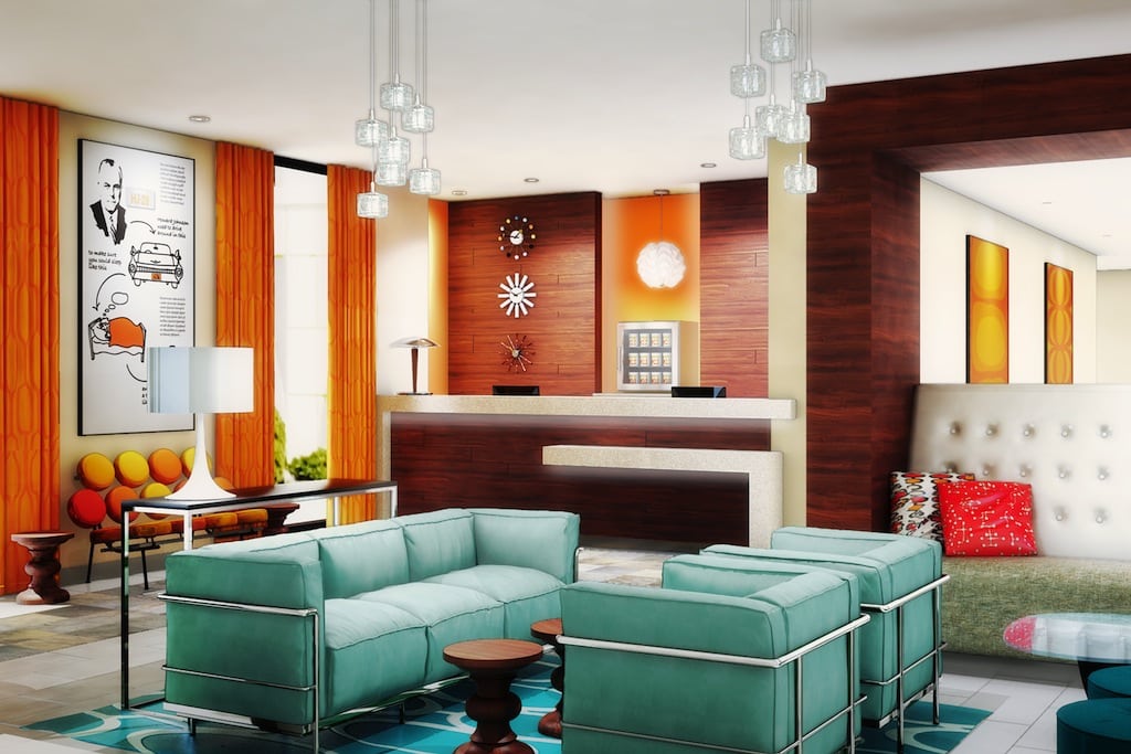 Howard Johnson's new lobby design is a mix of modern and retro furniture. The brights playful colors and fixtures are a 180 degree design change for the brand. 
