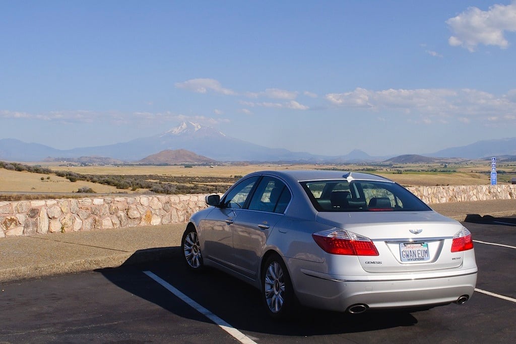 A Hyundai Genesis stop on 1-5 on a drive from Portland to California. A snow-capped Mt. Shasta can be seen in the distance. 